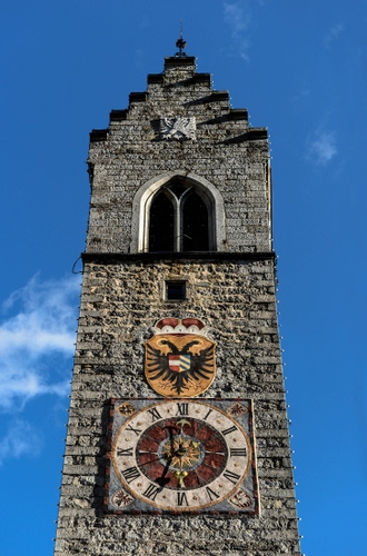 Immagine con orologio, stemma, bifora, cielo, campanile, torre, nuvole, finestra, lancette, numeri, azzurro, ore