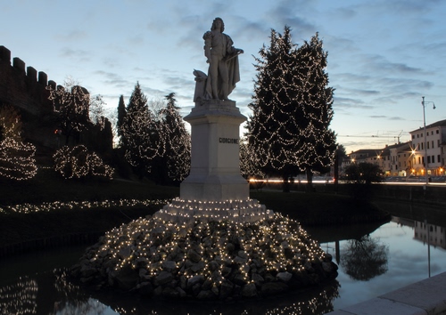 Immagine con statua, acqua, monumento, luci, alberi, luminarie, natale, fontana, riflesso, cielo