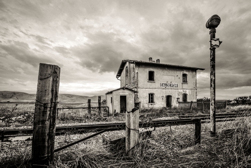 Immagine con stazione, bianconero, binari, casa, cielo, ferrovia, casello, nuvole, erba, palo